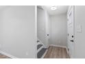 Bright hallway with wood floors, stairs to the second floor, and a white door at 70 Oregon Ln, Spring Lake, NC 28390