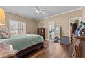 Cozy bedroom with hardwood floors, natural light, and a connected bathroom at 7053 Maple Cir, Sanford, NC 27332