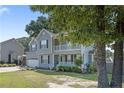 View of the side of a charming two-story home with gray siding and a front porch at 717 Lenoir Dr, Spring Lake, NC 28390