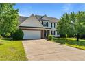 Inviting two-story home with a well-manicured lawn, showcasing a brick-accented facade and a spacious driveway at 81 Checkmate Ct, Cameron, NC 28326