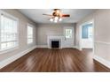 Bright living room with beautiful wood floors, fireplace, ceiling fan and natural light at 1001 N Orange Ave, Dunn, NC 28334