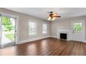 Bright living room with fireplace, ceiling fan, wood floors and natural light at 1001 N Orange Ave, Dunn, NC 28334