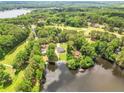 Wide angle aerial view of waterfront home on lake with pier and lush surroundings at 181 Tree Cutters, Sanford, NC 27332