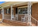 View of the front porch with decorative columns and seating at 209 4Th St, Erwin, NC 28339