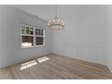 Dining room features a decorative chandelier, wainscoting detail and lots of natural light at 225 Persimmon Tree Dr, Cameron, NC 28326