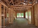 Interior framing of a new home showing exposed beams, studs, and construction materials at 275 Atkins Rd, Cameron, NC 28326