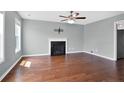 Bright living room features a fireplace, ceiling fan, and beautiful hardwood floors at 31 Boston Hbr, Cameron, NC 28326