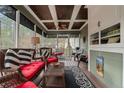 Spacious screened-in porch with stylish furnishings, ceiling fan, and views of the backyard at 60 Rolling Pines Dr, Spring Lake, NC 28390
