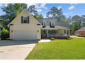 Charming one-story home with manicured lawn, attached garage, covered porch and dormer windows at 99 Riviera Ln, Sanford, NC 27332