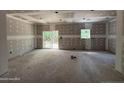 Unfinished open floor plan with sliding doors to the back yard and rough-in electrical at 2 Foxfire Blvd, Cameron, NC 27281