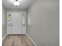 Welcoming foyer featuring stylish light-colored flooring, a white front door, and sidelight windows at 21 Dinghy Dr, Sanford, NC 27332
