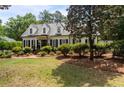 Charming two-story home with manicured lawn, mature trees and brick walkway at 2190 Keith Hills Rd, Lillington, NC 27546
