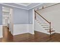 Inviting living room featuring hardwood floors, wainscoting, and a staircase at 252 School Side Dr, Spring Lake, NC 28390