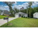Single-story home with an attached garage, nice lawn, and adjacent to other homes at 29 York Ct, Spring Lake, NC 28390