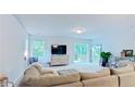 Bright and airy living room featuring a sliding glass door to the deck, windows and neutral color palette at 29 York Ct, Spring Lake, NC 28390