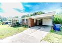 Quaint single story brick home featuring a convenient carport and well-maintained landscaping in a neighborhood at 2911 Wicker St, Sanford, NC 27330