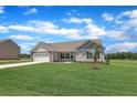 Well-maintained one-story home with a lush lawn, inviting facade, and a serene neighborhood setting at 107 Camp Rock Rd, Lillington, NC 27546