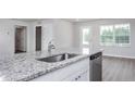 Close up of granite countertop with stainless steel sink, faucet and dishwasher in a modern kitchen at 107 Camp Rock Rd, Lillington, NC 27546