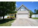 Attractive home boasts a well-maintained lawn, long driveway, and a two-car garage at 109 Red Coat Dr, Cameron, NC 28326
