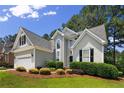 Beautifully landscaped home with a manicured lawn and attractive architectural details at 15 London Way, Spring Lake, NC 28390
