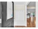 Welcoming entryway with built-in bench and coat hooks and view to open living area at 2003 Spring Ln, Sanford, NC 27330