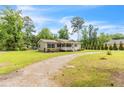 Well-maintained home with a long driveway and lush green lawn at 2003 Spring Ln, Sanford, NC 27330