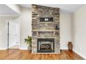 A stacked stone fireplace with a wood mantel is the focal point of this living space at 2003 Spring Ln, Sanford, NC 27330