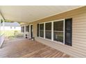 Covered front porch with wood decking and space for seating, perfect for relaxing outdoors at 2003 Spring Ln, Sanford, NC 27330