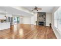 Spacious living area with stone fireplace, hardwood floors, and access to kitchen and outdoor deck at 2003 Spring Ln, Sanford, NC 27330