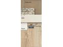 Selection of interior finishes, including Mohawk LVP flooring, granite kitchen countertop, and paint samples at 219 Uwharrie Way, Sanford, NC 27330