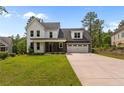 Charming two-story home with a well-manicured lawn, covered entry, and a two car garage at 25 Clearwater Hbr, Sanford, NC 27332