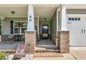 Inviting front porch with brick accents, seating, and a welcoming entrance at 40 Savanah Ct, Sanford, NC 27332