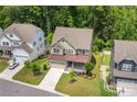 Aerial view of this home showcasing mature trees, lawn and proximity to neighboring homes at 405 Gilpin Way, Cary, NC 27519