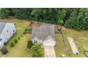 Aerial view of a home with a fenced yard, mature trees, and a well-maintained exterior at 841 Golden Horseshoe Ln, Sanford, NC 27330