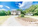 Lovely two-story white home with a spacious yard, RV parking, and lush greenery at 1001 Dycus Rd, Sanford, NC 27330