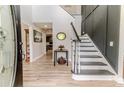 Welcoming foyer with paneled walls, beautiful staircase, and attractive wood-look flooring at 1001 Dycus Rd, Sanford, NC 27330