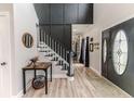 Inviting foyer featuring paneled walls, staircase, and gleaming floors at 1001 Dycus Rd, Sanford, NC 27330