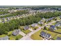 Aerial view of a residential neighborhood showcasing homes with mature trees and green spaces at 106 Linden Rd, Cameron, NC 28326