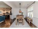 Elegant dining room with hardwood floors, a farmhouse table, and natural light from a large window at 30 Regal Pond Dr, Angier, NC 27501