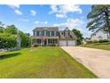 Beautiful two-story home with a well-maintained lawn, inviting porch, and convenient two-car garage at 383 Yorkshire Dr, Cameron, NC 28326