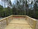 New construction deck area with wood railing, ideal for outdoor enjoyment and entertaining at 41 Horse Trot Ln, Sanford, NC 27332