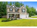Charming two-story home with a covered front porch, well-manicured lawn and an attached two-car garage at 446 Birch Ave, Spring Lake, NC 28390