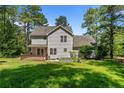 The home showcases a wooden deck and manicured lawn with plenty of trees and well-kept landscaping at 120 Forest Pond Rd, Cameron, NC 28326