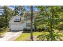 Two-story home with attached garage, manicured lawn, and lovely landscaping, framed by mature trees at 120 Forest Pond Rd, Cameron, NC 28326