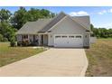 Charming single-story home with a two-car garage and a well-maintained front yard and long driveway at 152 Goose Creek Cir, Dunn, NC 28334