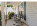 Cozy front porch area with charming rocking chairs and views of the surrounding landscape at 152 Goose Creek Cir, Dunn, NC 28334