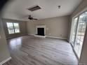 Bright living area featuring modern flooring, a fireplace, and sliding glass doors at 19 Ribbon Oak Ct, Sanford, NC 27332