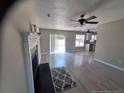 Bright living area with hardwood flooring, fireplace, and sliding glass door at 19 Ribbon Oak Ct, Sanford, NC 27332