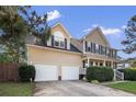 Beautiful home featuring a classic columned front porch and an attached two-car garage at 40 Union Cir, Lillington, NC 27546