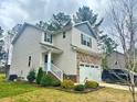 Attractive two-story home with a well-kept lawn, a two car garage, and mature landscaping at 50 Teal Dr, Youngsville, NC 27596